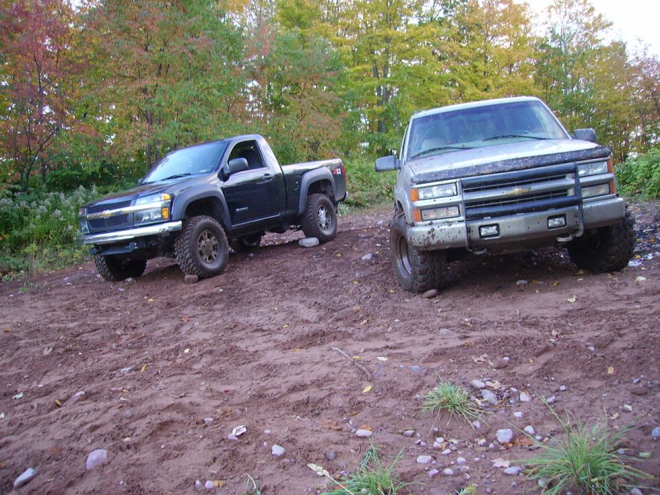Silver pickup truck front view, lifted with off-road tires