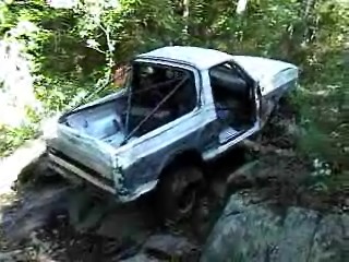 1995 Ford Bronco - This Ford Bronco appears to be navigating a challenging off-road terrain with its doors open.