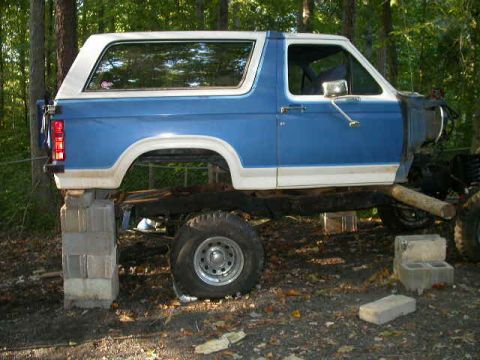 1990 Ford Bronco - This vehicle appears to be undergoing some form of repair or modification, as it is elevated on blocks and missing its front end.