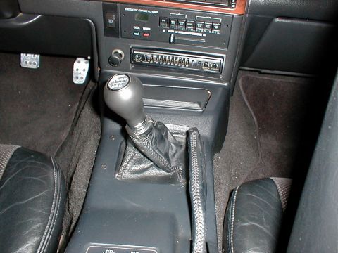 1993 Ford Thunderbird - Interior view of a car's center console, highlighting the manual transmission shifter and dashboard controls.