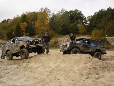 1979 Ford Bronco - Two Ford Broncos are parked on a sandy hill during an off-road excursion.