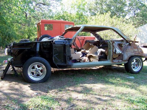 1964 Mercury Comet - This 1964 Mercury Comet coupe is in a state of disassembly, revealing its interior and rusted body panels.