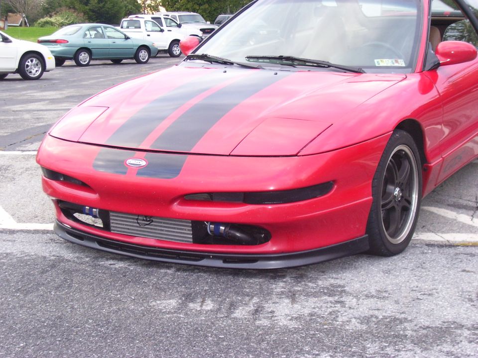 1997 Ford Probe front view, red with black racing stripes, aftermarket intercooler visible