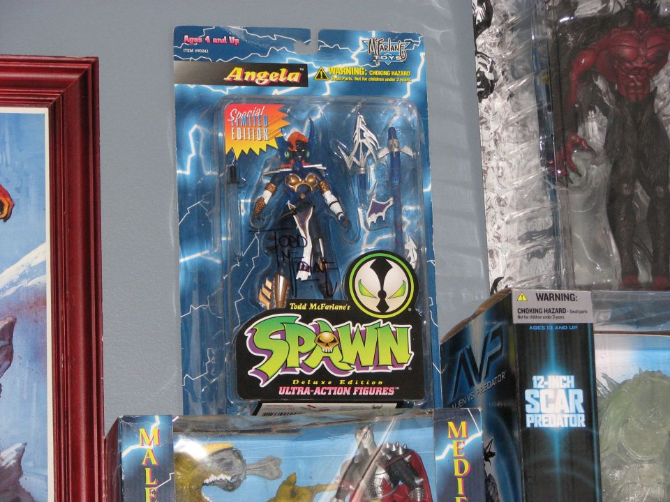 Action figure of Angela from Spawn in packaging with lightning background