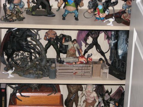 1991 Ford Bronco - A collection of detailed horror-themed action figures are displayed on shelves, some in violent or macabre scenes.