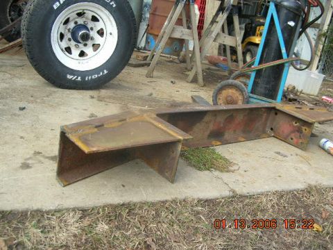 1991 Ford F-150 - Several pieces of rusted metal, possibly from a vehicle, lie on the ground next to a tire.