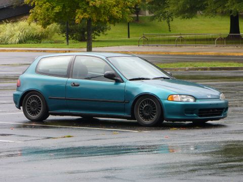 1991 Ford Probe - A teal Honda Civic hatchback from the early 1990s is parked in a lot.