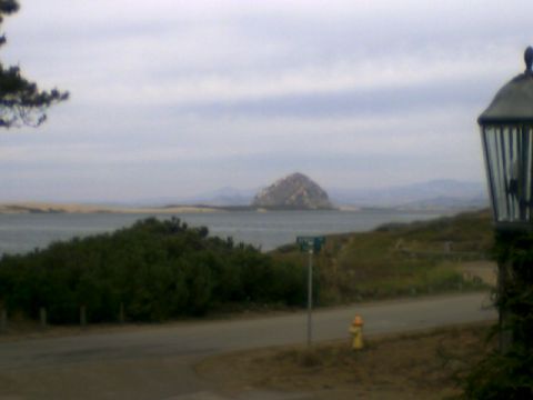 1973 Ford Ranchero - View of Morro Rock from a coastal road, with a fire hydrant and street sign visible.