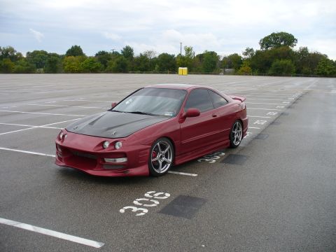 1991 Ford Probe - This red coupe features a carbon fiber hood and aftermarket body kit.