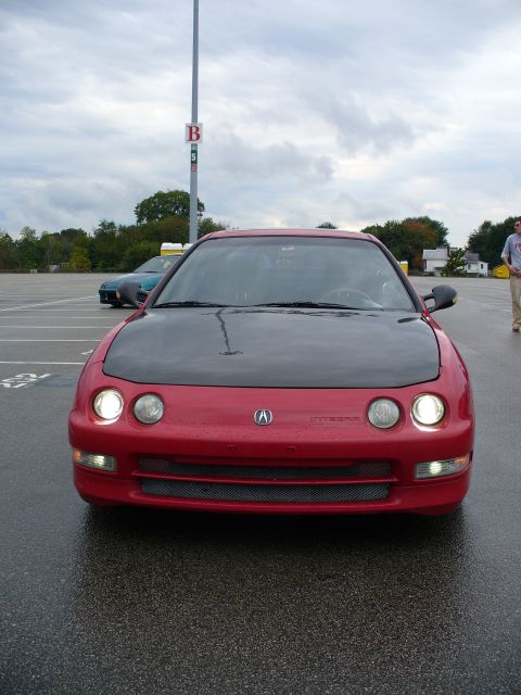 1991 Ford Probe - Red Acura Integra with a black hood in a parking lot, another car in the background.