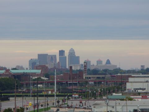 1991 Ford Probe - A wide view of a city skyline various buildings, including a prominent clock tower, under an overcast sky.