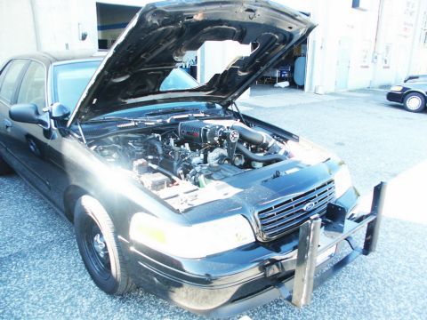 2001 Mercury Grand Marquis - Ford Crown Victoria with a supercharger installed, hood up. Another Crown Victoria in background.