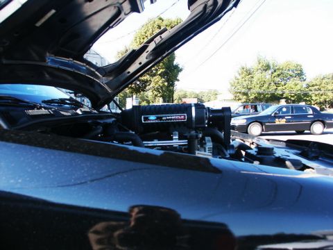 2001 Mercury Grand Marquis - A black 2001 Mercury Grand Marquis is shown with its hood open, revealing a supercharger under the hood.
