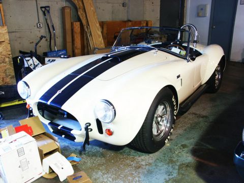 2001 Mercury Grand Marquis - White AC Cobra replica with black racing stripes parked in a garage with boxes nearby.