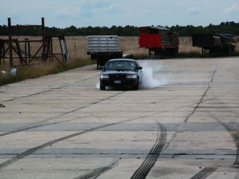 2001 Mercury Grand Marquis - 2001 Mercury Grand Marquis performing a burnout, creating a large cloud of smoke.