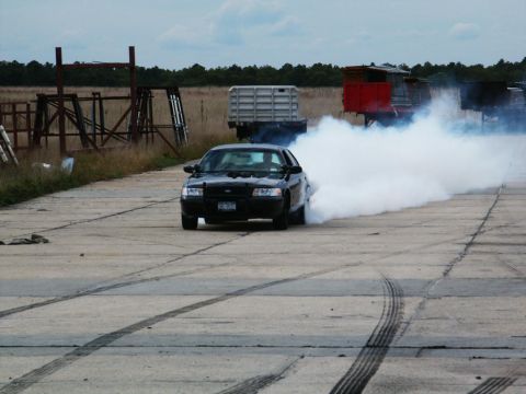 2001 Mercury Grand Marquis - A black 2001 Mercury Grand Marquis is seen performing a burnout, creating a large cloud of smoke.