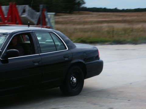 2001 Mercury Grand Marquis - Side view of a black 2001 Mercury Grand Marquis in motion.
