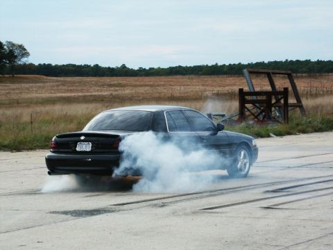 2001 Mercury Grand Marquis - A black 2001 Mercury Grand Marquis is seen performing a burnout, kicking up a large cloud of smoke.