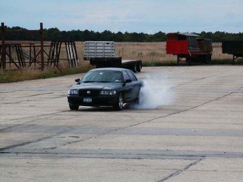 2001 Mercury Grand Marquis - 2001 Mercury Grand Marquis performing a burnout, kicking up a cloud of smoke.