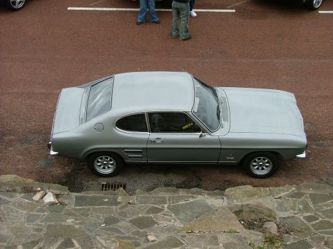 2001 Ford Fiesta - This silver coupe features a distinctive fastback roofline and triple side vents, indicative of a 1970s model.