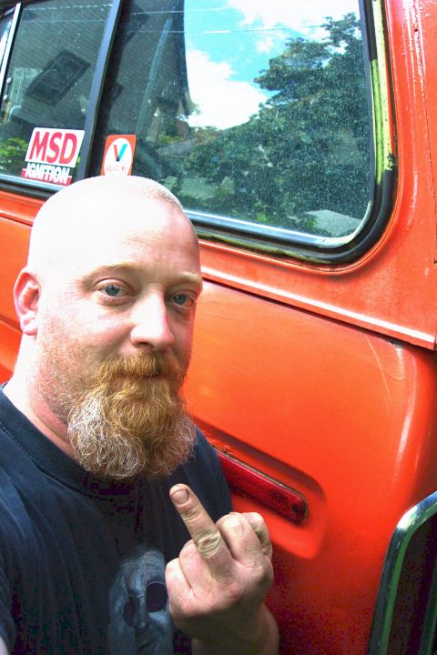 1978 Ford Bronco - A man poses in front of an orange vehicle, which has an MSD Ignition sticker on the window.