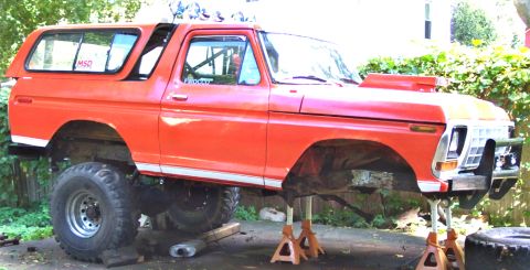 1978 Ford Bronco - This lifted Ford Bronco is on jack stands with its front end elevated for maintenance.