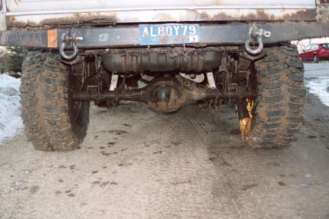 1979 Ford Bronco - Muddy rear axle and tires on a vehicle with a license plate from 1979.