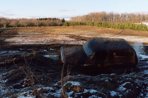 1979 Ford Bronco - This vehicle is deeply stuck in mud and appears to be partially submerged.