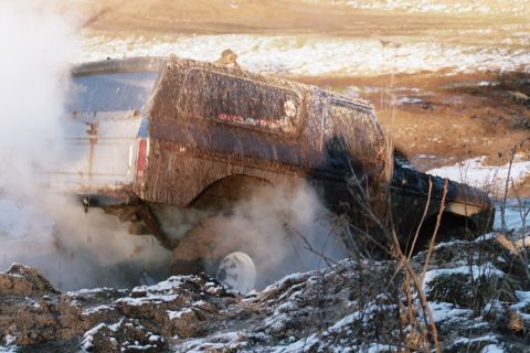 1979 Ford Bronco - Two vehicles are stuck in the mud during a winter event.