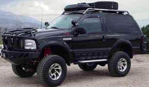 Black lifted two-door SUV with roof rack, brush guard and off-road tires, 3/4 front view