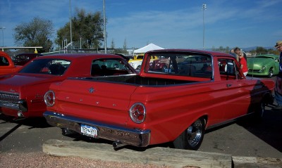 1972 Ford Ranchero - A red pickup truck is parked at an outdoor event with other vehicles visible.
