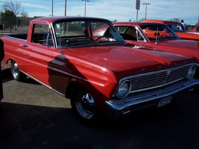 1972 Ford Ranchero - A red 1964 Ford Ranchero is seen from a 3/4 front view, parked alongside other vehicles.