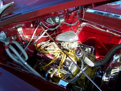 1972 Ford Ranchero - The engine bay of a 1972 Ford Ranchero features a V8 engine with chrome accents and yellow spark plug wires.