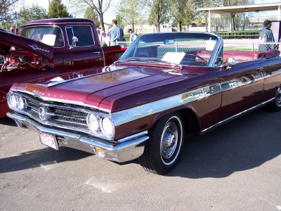 1972 Ford Ranchero - Two maroon vehicles, a 1962 Buick Skylark convertible and a pickup truck, are parked outdoors.