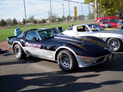 1972 Ford Ranchero - A black and silver Chevrolet Corvette, identified as an 'Official Pace Car', is parked next to other vehicles.