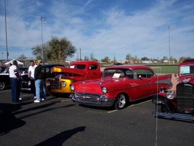 1972 Ford Ranchero - Several classic vehicles are on display outdoors under a bright blue sky with scattered clouds.