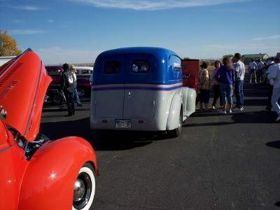 1972 Ford Ranchero - A custom van with a blue top and gray body is parked at an outdoor event with other vehicles and people.