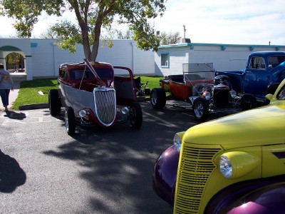 1972 Ford Ranchero - A collection of vintage hot rod cars are parked outdoors under a tree.