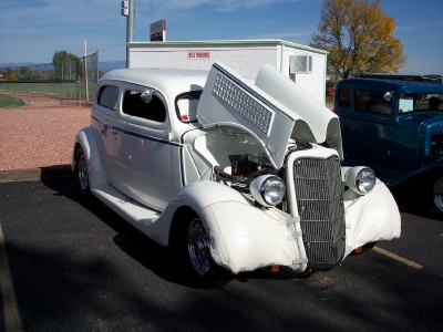 1972 Ford Ranchero - A white 1935 sedan is displayed with its hood open, revealing the engine compartment.