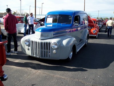 1972 Ford Ranchero - A two-tone blue and gray panel van is parked at an outdoor event with other vehicles.