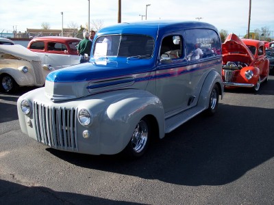 1972 Ford Ranchero - A two-tone panel van is parked in a lot with other vehicles.