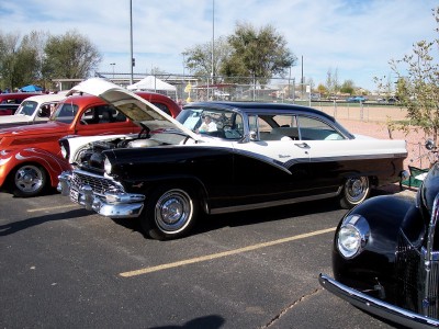 1972 Ford Ranchero - A black and white 1956 Ford Fairlane Crown Victoria is displayed with its hood open at an outdoor car show.