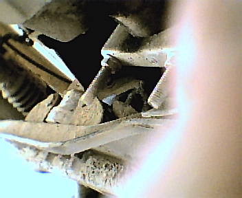 1987 Ford Bronco - The image shows damaged suspension components, with the Supermotors.net logo visible in the lower right corner.