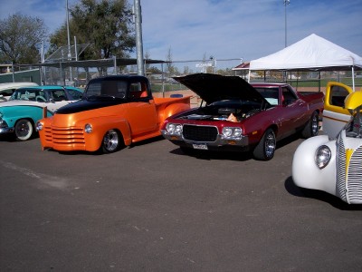1972 Ford Ranchero - Several vintage vehicles, including a 1972 Ford Ranchero, are displayed at an outdoor event.