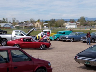 1972 Ford Ranchero - A red 1967 coupe is displayed with its hood open at a car show, surrounded by other vehicles.