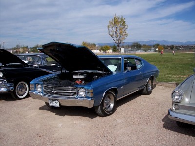 1972 Ford Ranchero - A blue 1972 Ford Ranchero is parked with its hood open, alongside other vehicles.