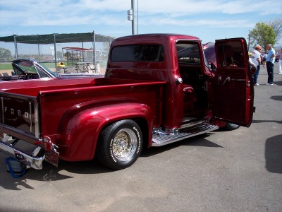 1972 Ford Ranchero - This classic red 1956 Ford F-100 pickup truck is displayed with its doors open, revealing its interior.