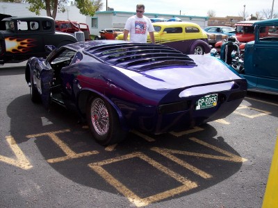 1972 Ford Ranchero - Custom purple sports car parked in a lot with other vehicles. License plate is GP-6055.