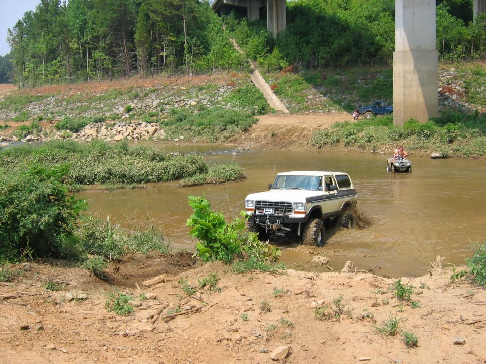 White Ford Bronco driving through water, off-road