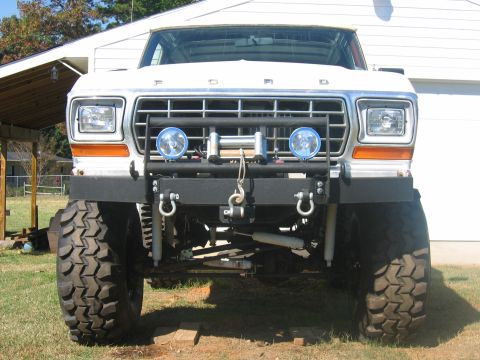1992 Ford Mustang - This lifted Ford truck features a winch and auxiliary lights mounted on a heavy-duty bumper.